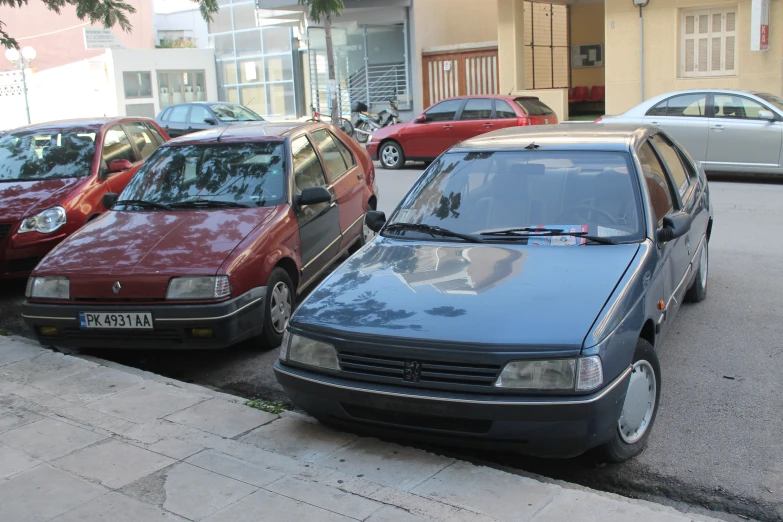 several cars parked in front of each other along a curb