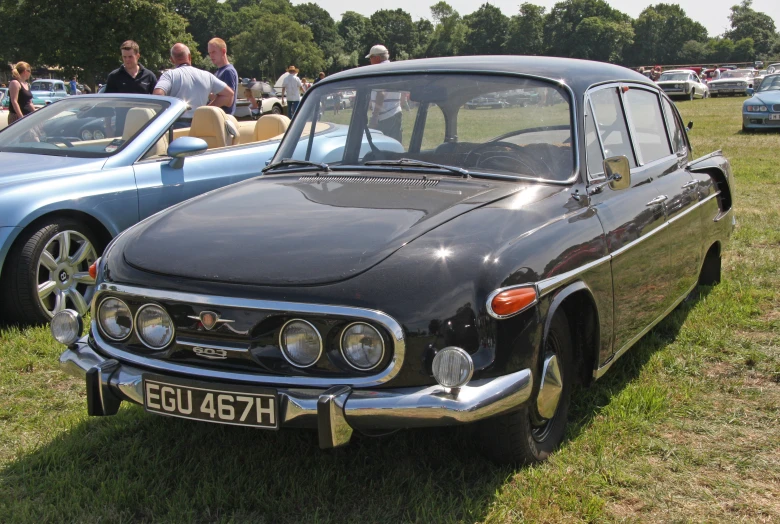 a vintage black car on display at an event
