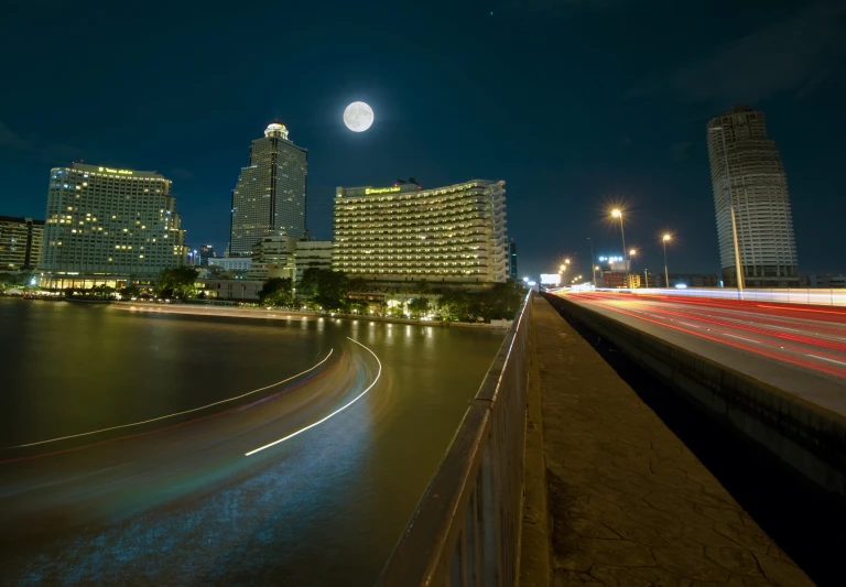 a large city at night with cars traveling along it