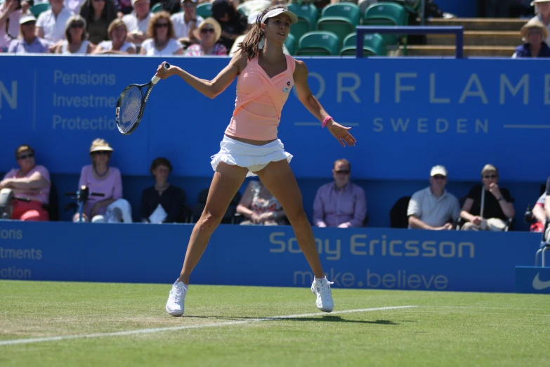 woman holding tennis racket while playing tennis game