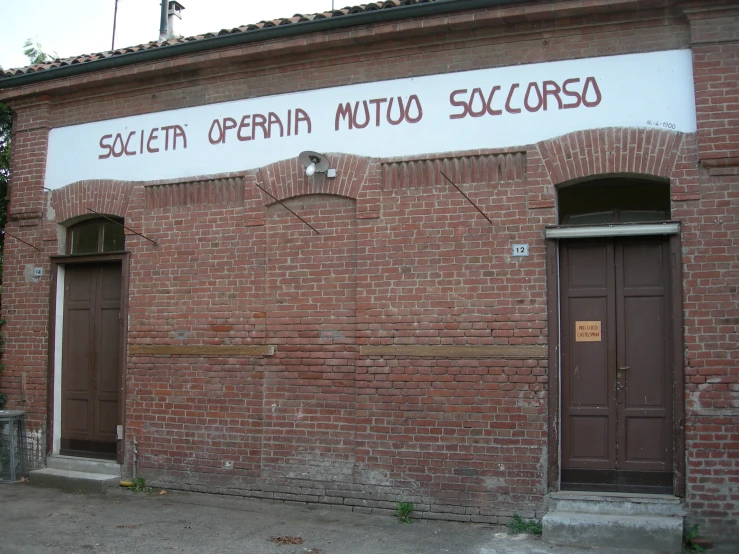 a sign is on the side of a brick building