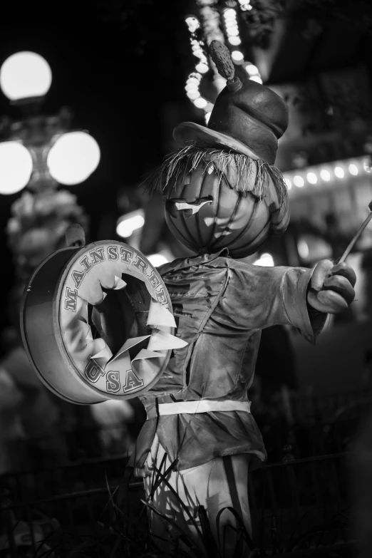 a statue of clown holding onto a small clock