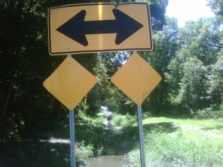 three signs showing the direction of an intersection