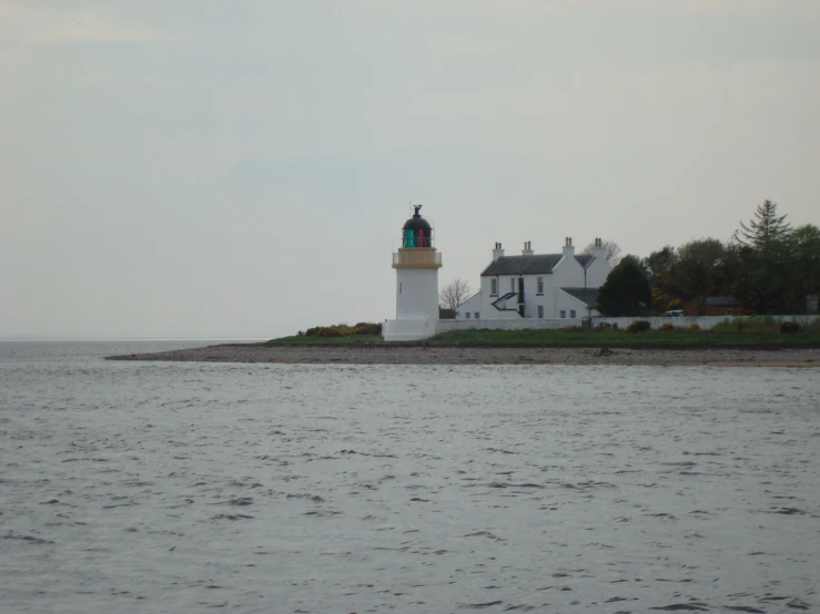 a lighthouse is perched atop an island in the ocean