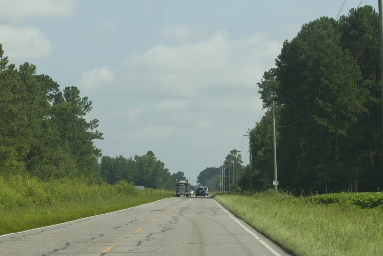 a view from inside the front of a car going up a hill