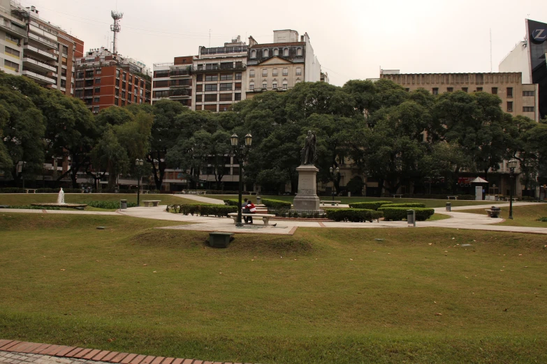 there are many people sitting around in the park