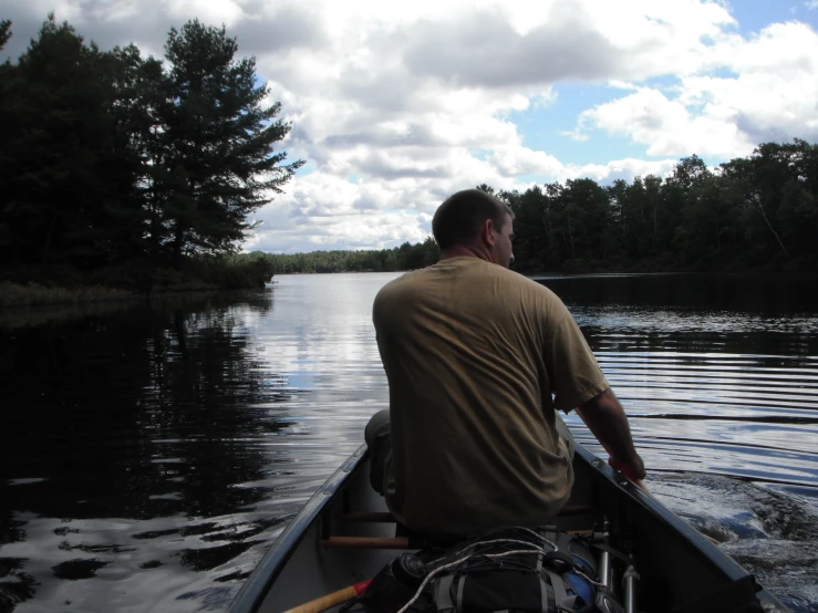 a man in a boat on a lake