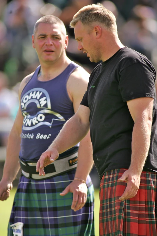 two men in kilts standing next to each other