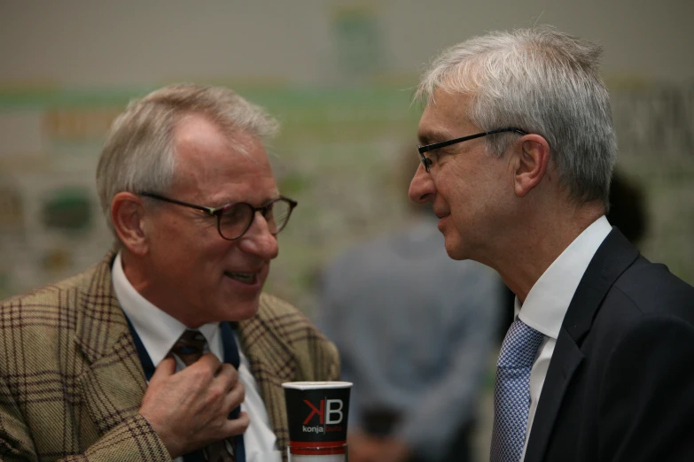 two men talk and smile at each other