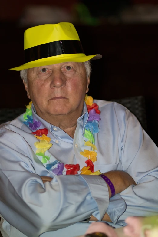 an older man wearing a brightly colored hat