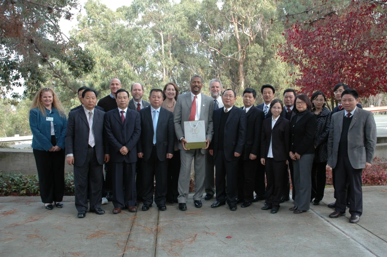 people standing in suits and ties are standing in a group