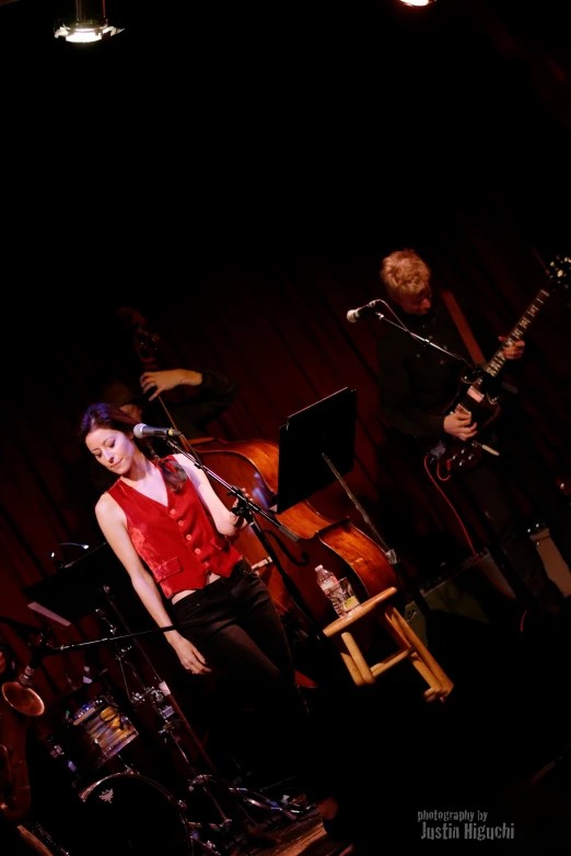 a woman standing on stage with a microphone