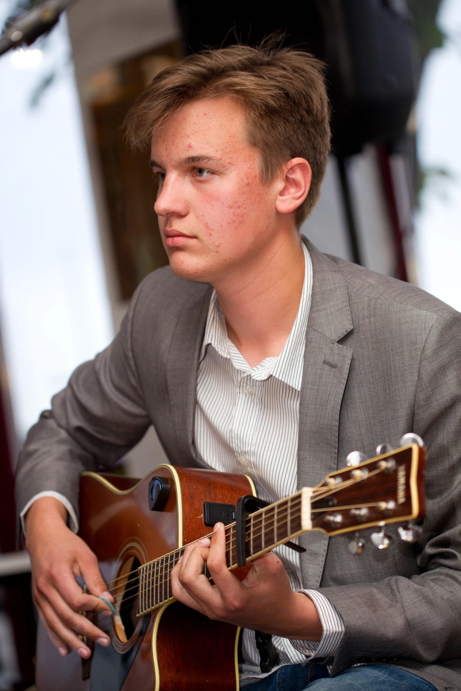 a young man playing the guitar on stage