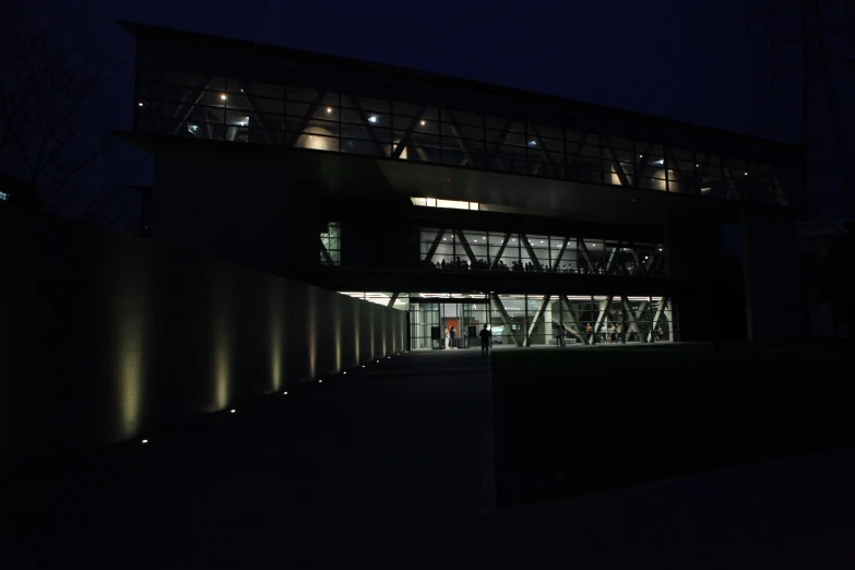 a building with multiple windows lit up at night