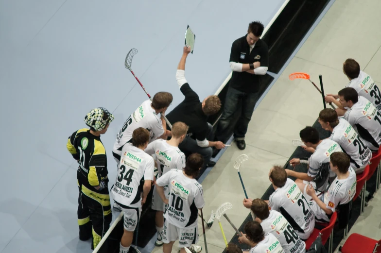 two teams with players in stands with one getting ready to play