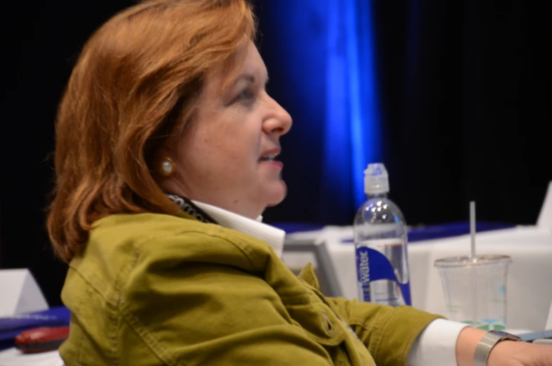 a red headed woman is at a table and is sitting down