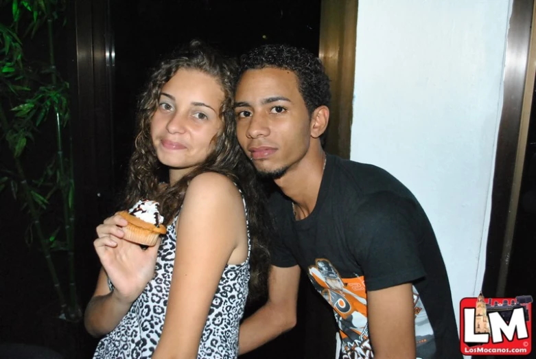 a man holding a half eaten doughnut next to his partner