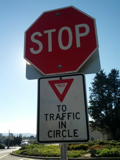 there is a stop sign with traffic in circle