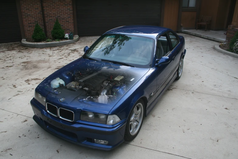 a blue bmw car with a hood covered in engine fluid