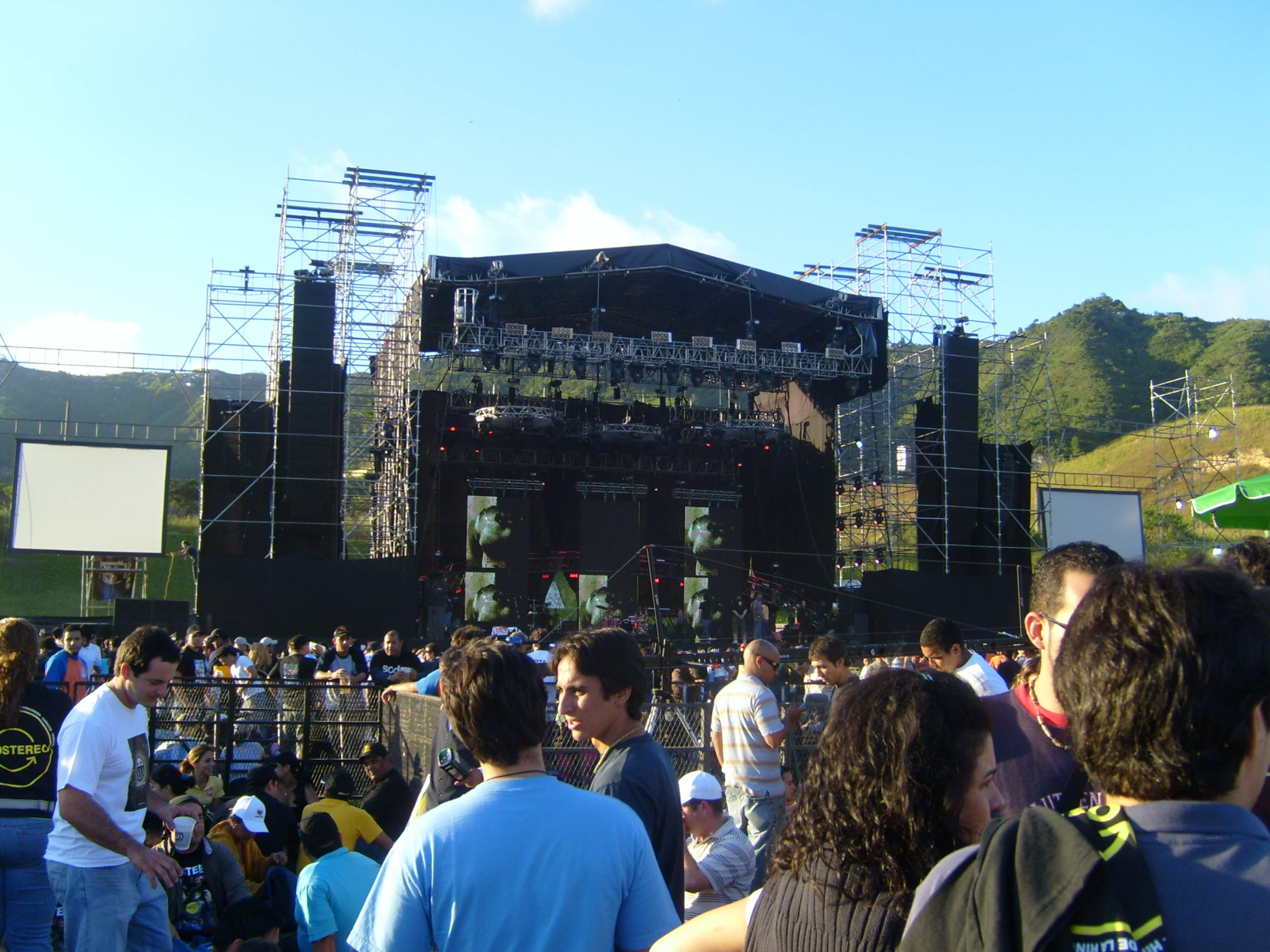 a large group of people stand at an outdoor stage