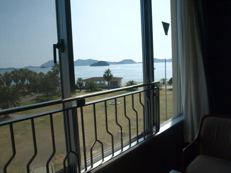 the view from inside a house looking out to a lake