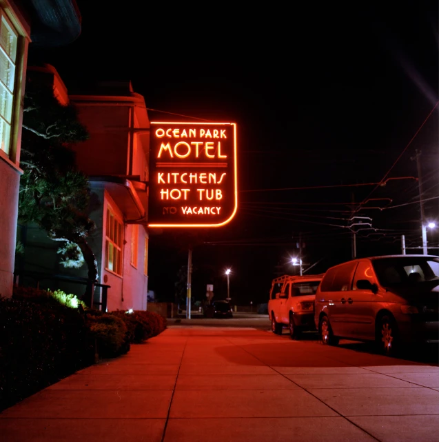 a sign for an ocean park motel lit up at night