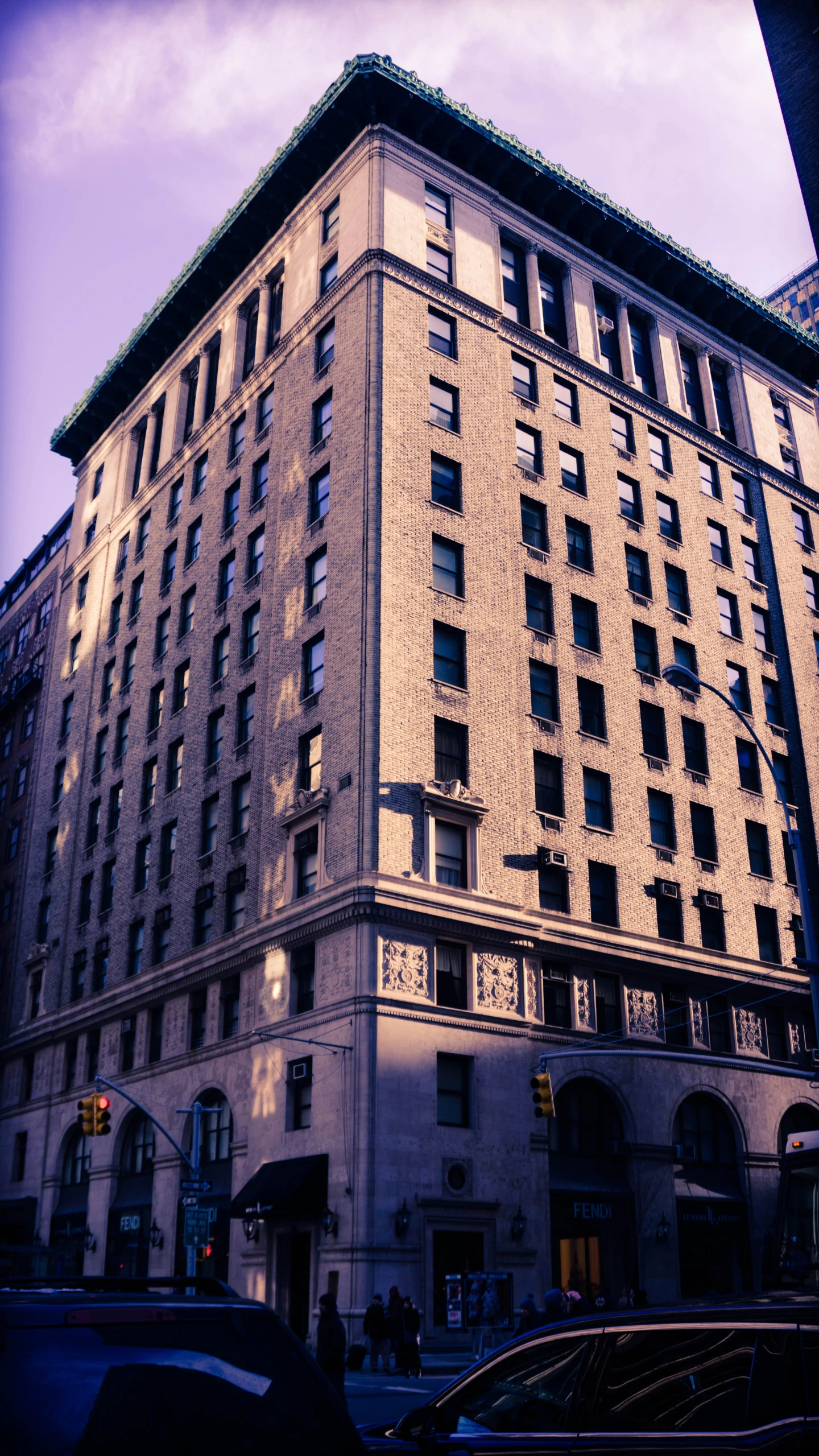 a big building sitting next to a tall yellow brick building