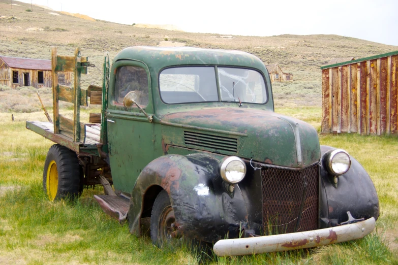 a old pickup truck parked in the grass