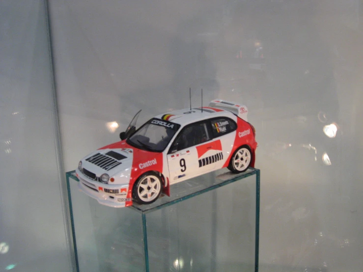a model car displayed on a glass table