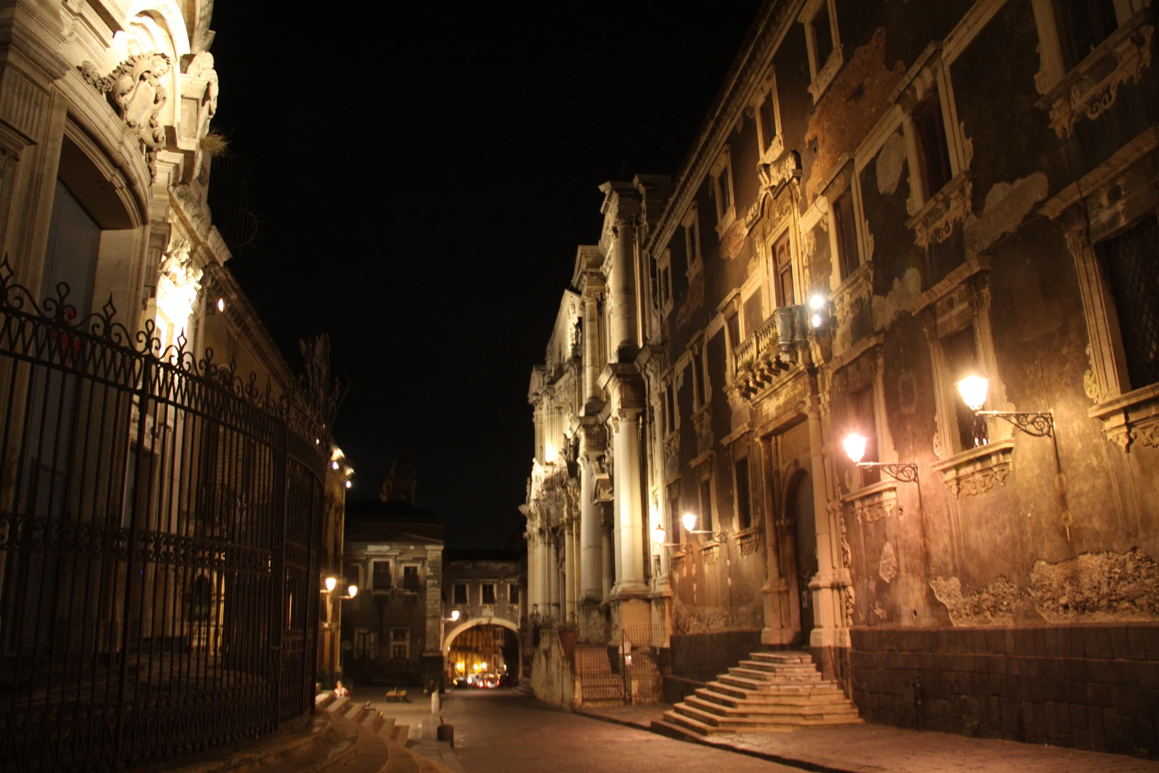 an alley leading into some very old stone buildings