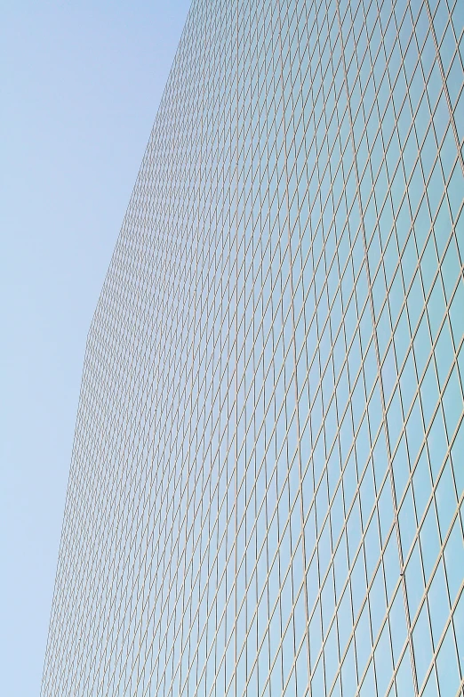 a building with a sky background that appears to be a diagonal window