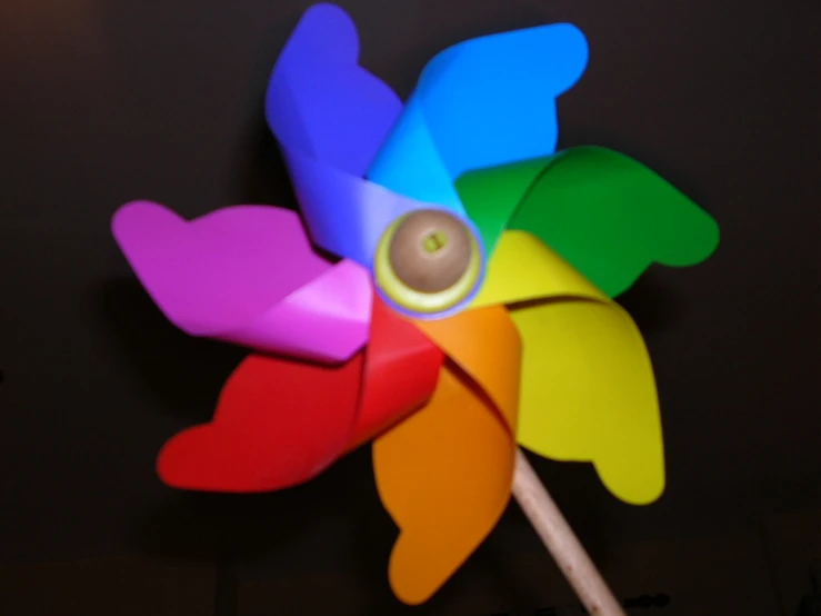 colorful paper flowers are painted with different colors