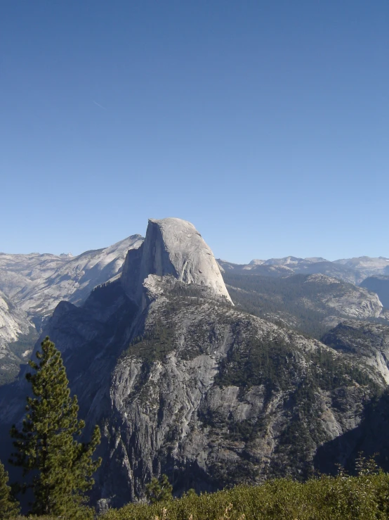 a mountain view with trees and mountains in the background