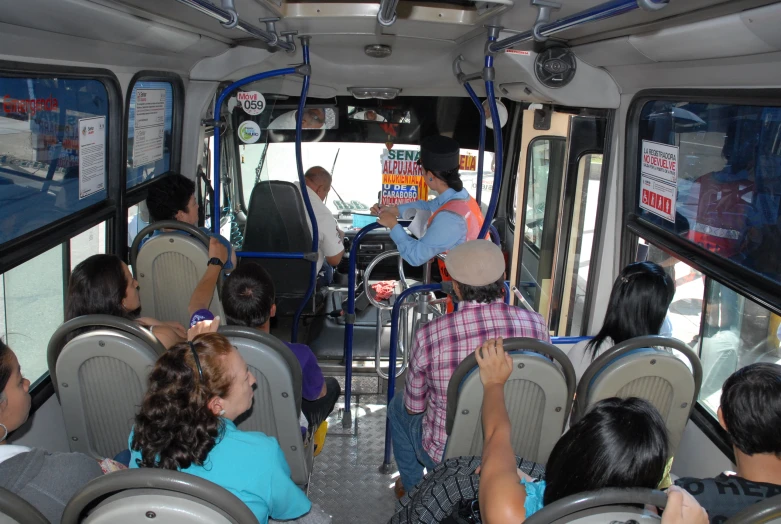 the people are riding on the bus as they travel