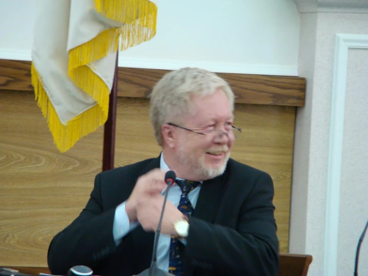 a man is laughing in front of an audience