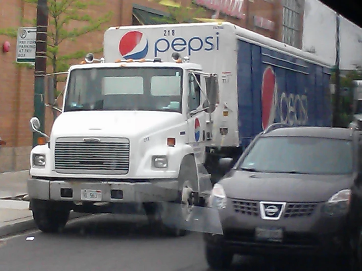 a pepsi delivery truck pulling out of a parking space