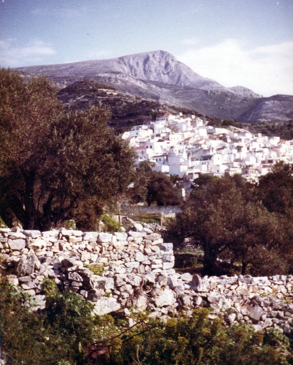 a mountain village next to the ocean in a rocky area