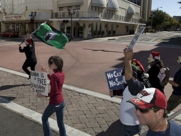 people holding signs and flags outside on the street