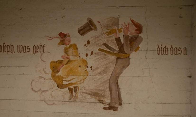 an artistic wall painting depicts a person with a hat