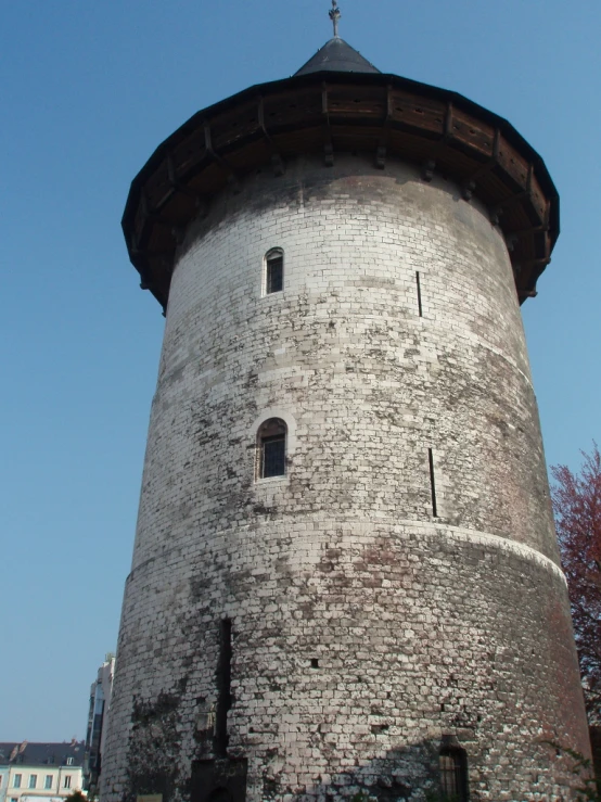 a tall brick tower with a cross on top