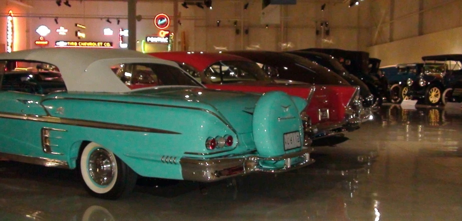 old classic cars on display inside of a building