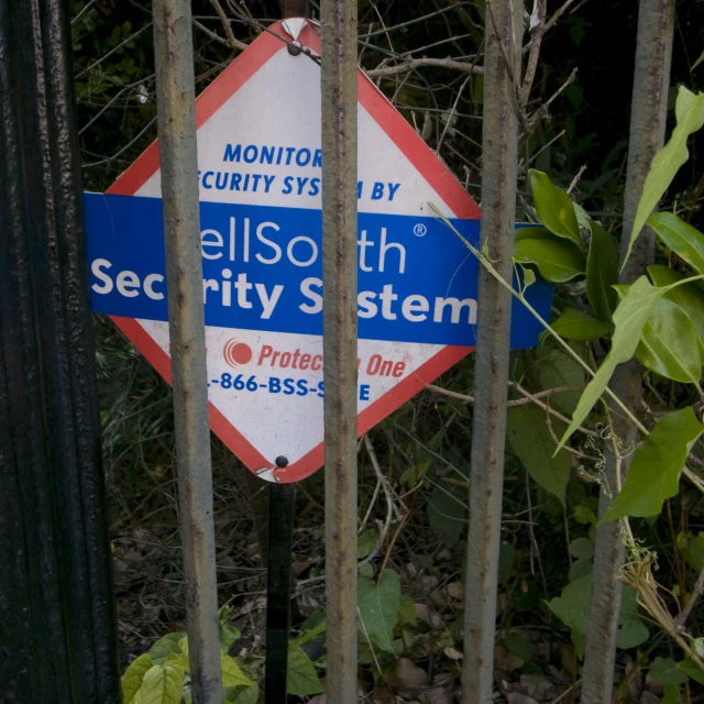 a street sign sits near some metal bars