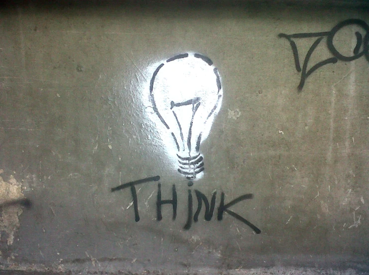 graffiti on a wall of an open light bulb