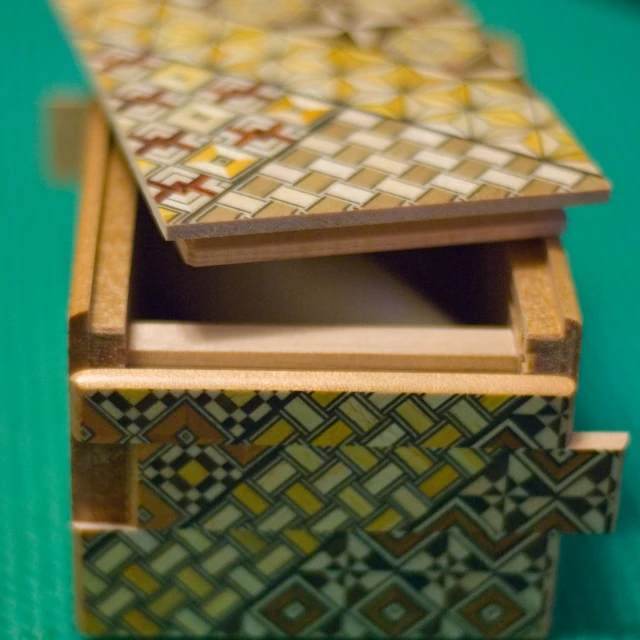 a toy wooden box is holding some miniature tiles