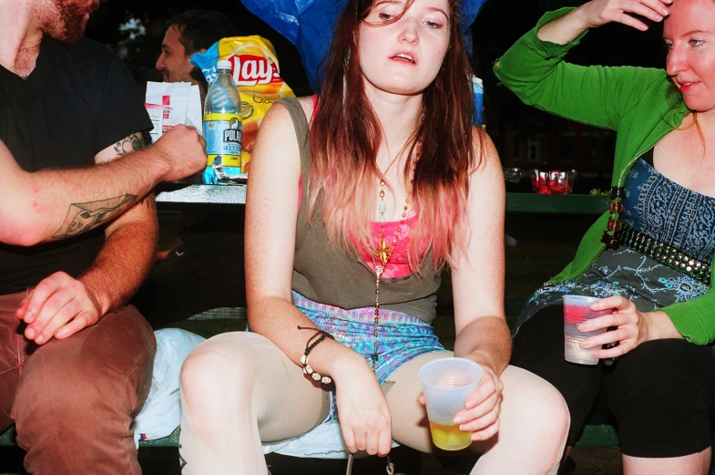 people sitting next to each other, drinking beer