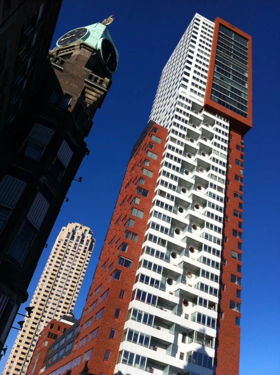 a large tall skyscr stands next to other buildings