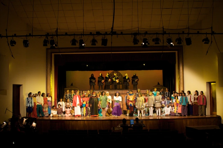 group of performers on stage with spotlight on the audience