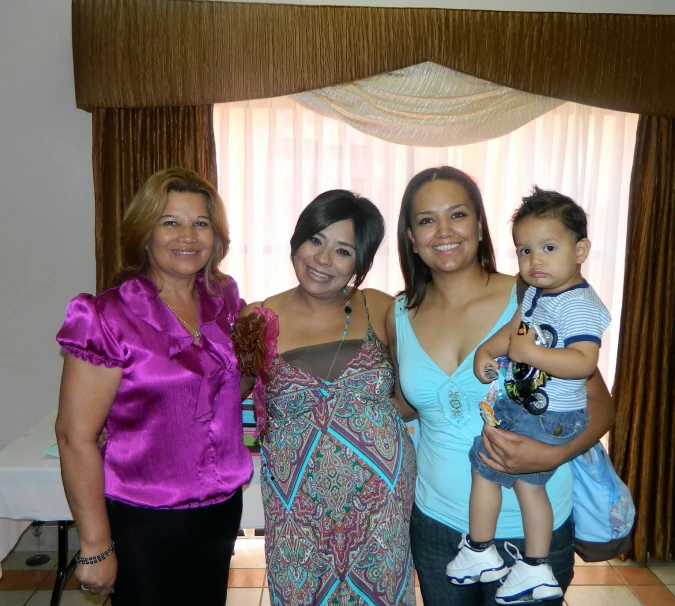 two women and one boy standing together smiling