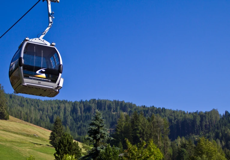 a gondola that has two passengers in the air