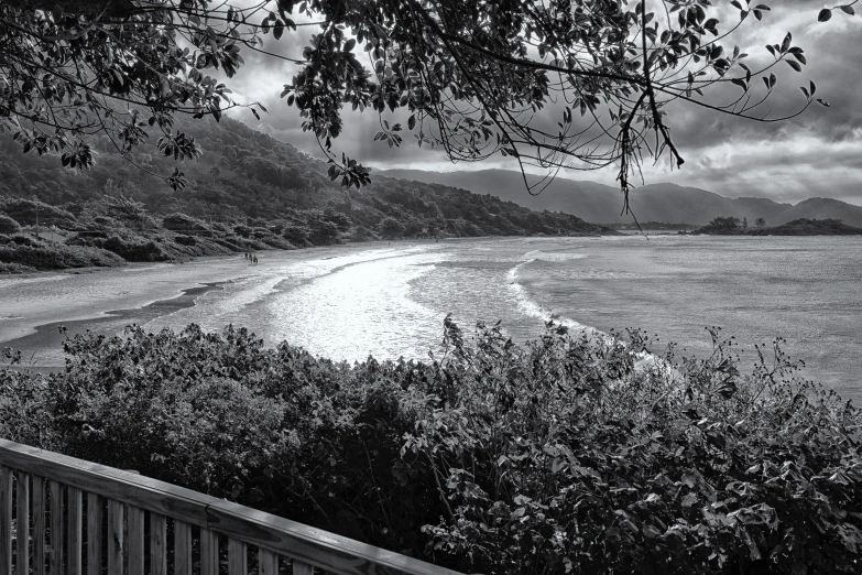 a wooden bench sitting in front of a lush green valley